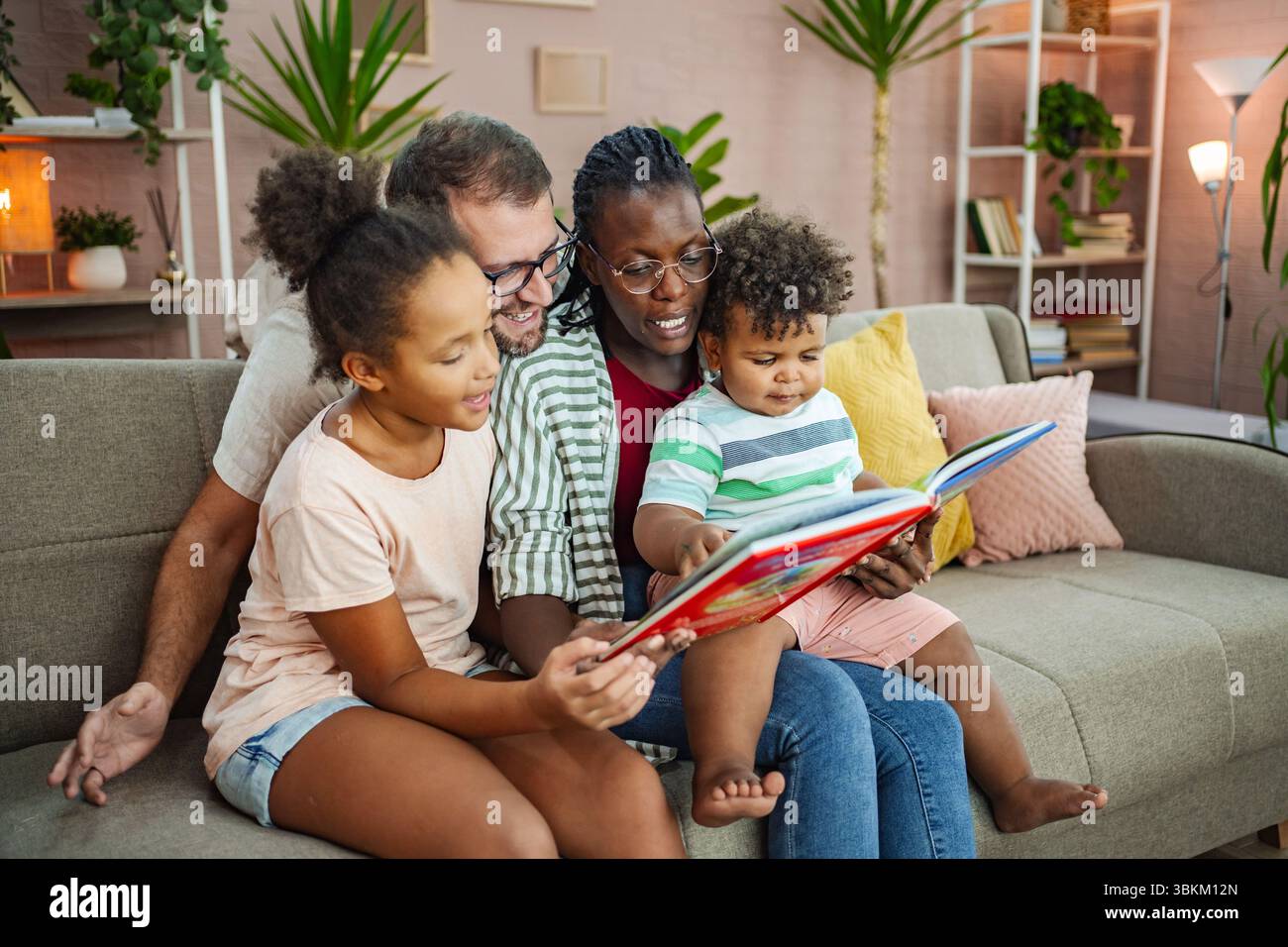 Cozy living room storytime family bonding Stock Photo - Alamy