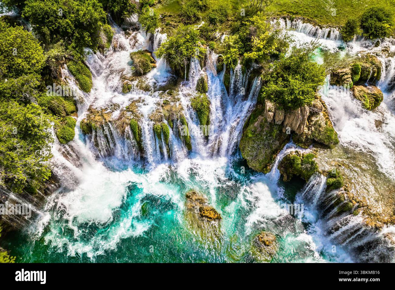 Top down view showing the cascading waterfalls surrounded by greenery ...