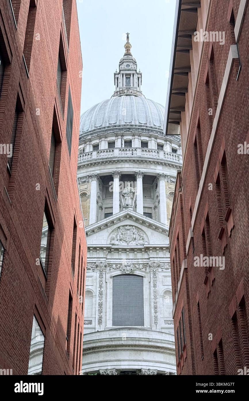 St Paul’s Cathedral seen through avenue between red brick buildings from Paternoster Square - Smartphone Captured Stock Image