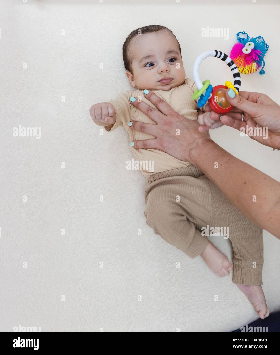 Kids Using Rattle Baby visual tracking hi-res stock photography and images - Alamy