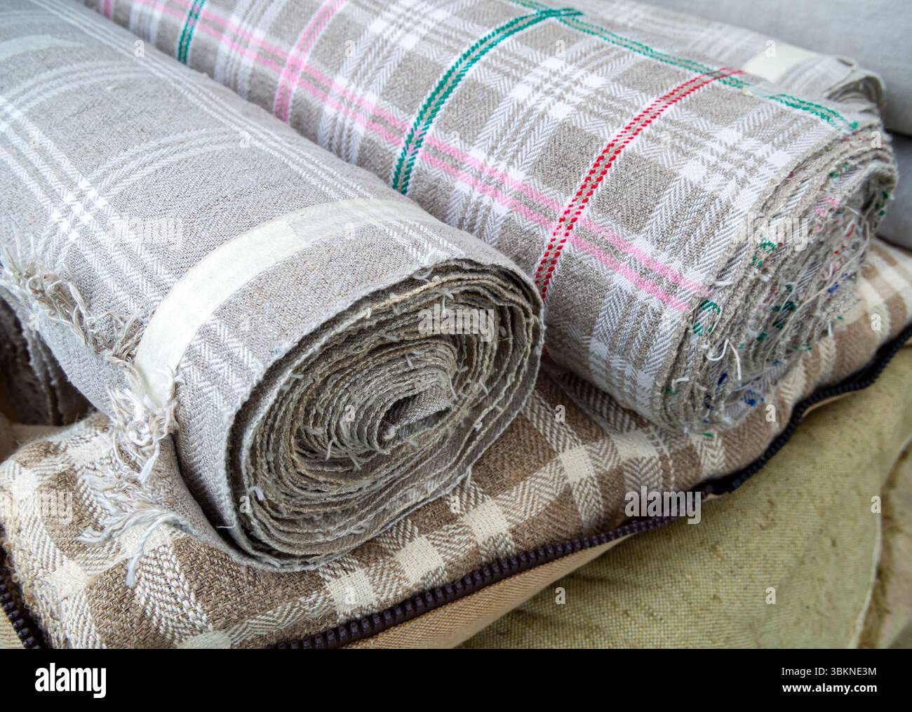 Rolls of linen fabric with a checkered pattern Stock Photo