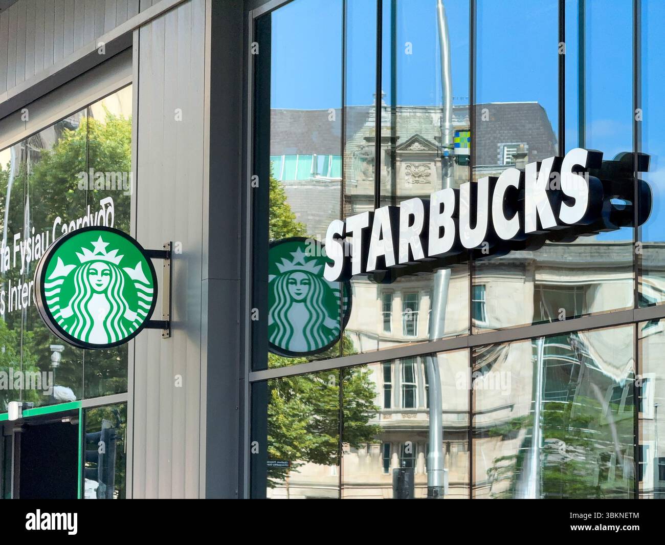 Cardiff, Wales, UK - 18 June 2025: Sign above the entrance to a branch of Starbucks in Cardiff city centre - Smartphone Captured Stock Image Cardiff, Wales, UK - 18 June 2025: Sign above the entrance to a branch of Starbucks in Cardiff city centre - Smartphone Captured Stock Image