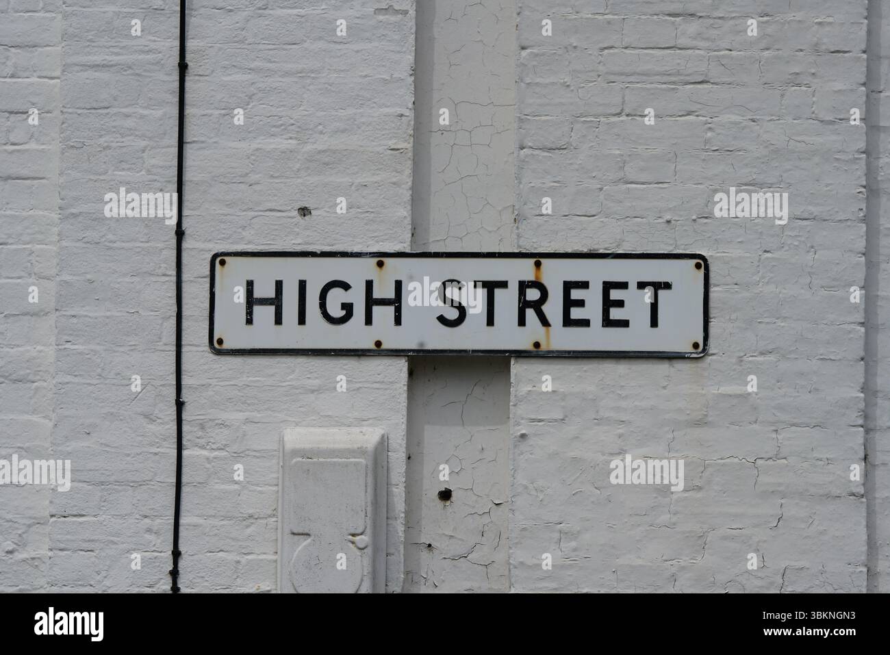Urban High Street Sign Mounted on a Brick Wall in Daytime. Guildford, England Stock Photo