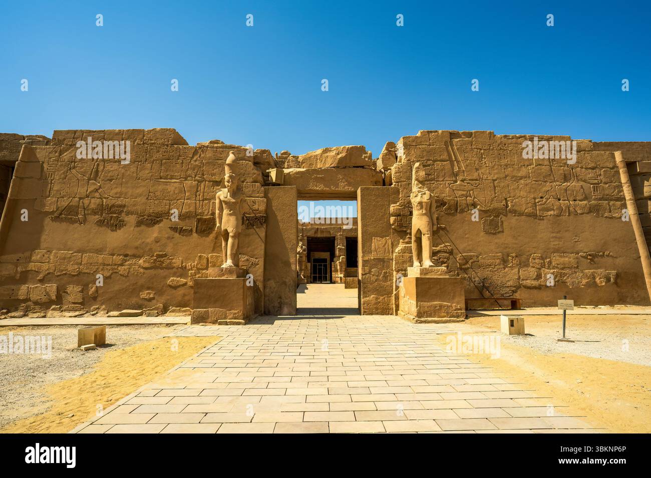 Ancient Egyptian temple entrance with carved statues and hieroglyphs at ...