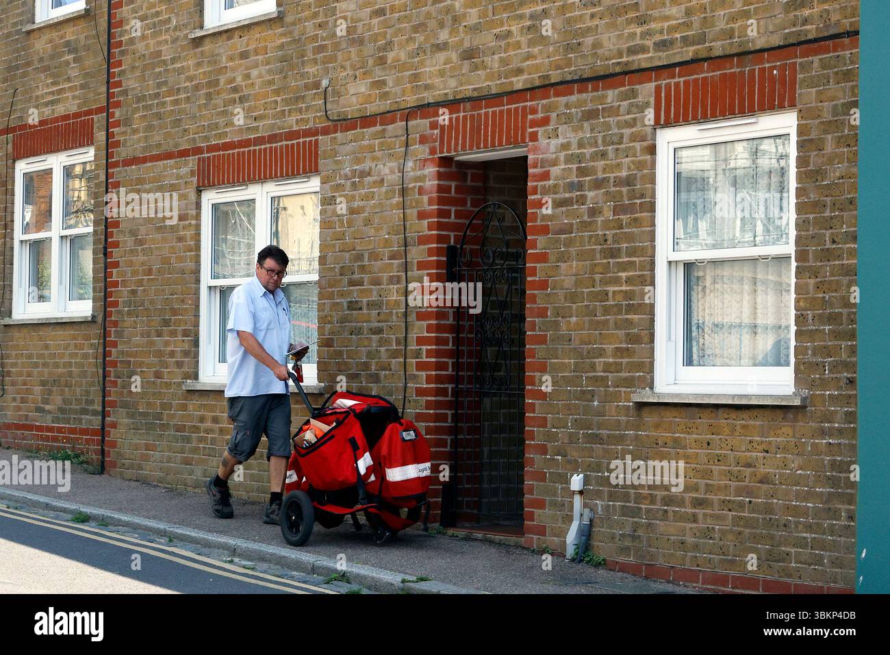 Postman delivering mail Stock Photo