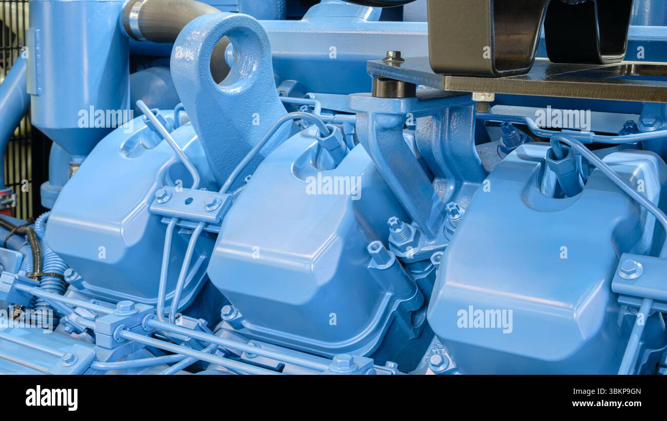 Blue engine with three cylinders. The engine is in a factory Stock ...
