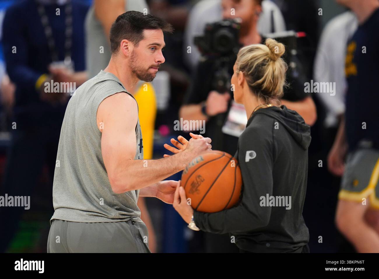 Indiana Pacers guard T.J. McConnell, left, greets assistant coach Jenny