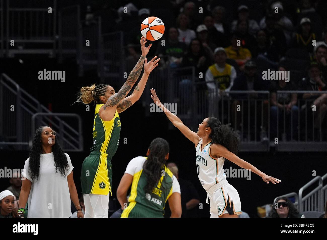 Seattle Storm forward Gabby Williams, left, makes a three-point basket ...