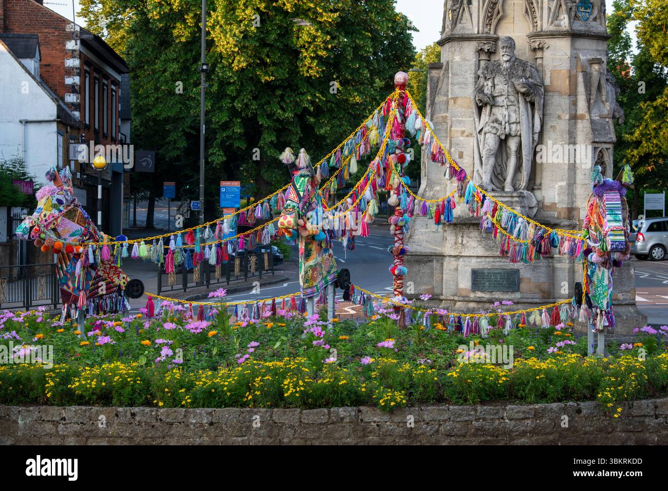 Colourful hobby horse display in front of Banbury cross, in the early morning. Banbury, Oxfordshire, England Stock Photo
