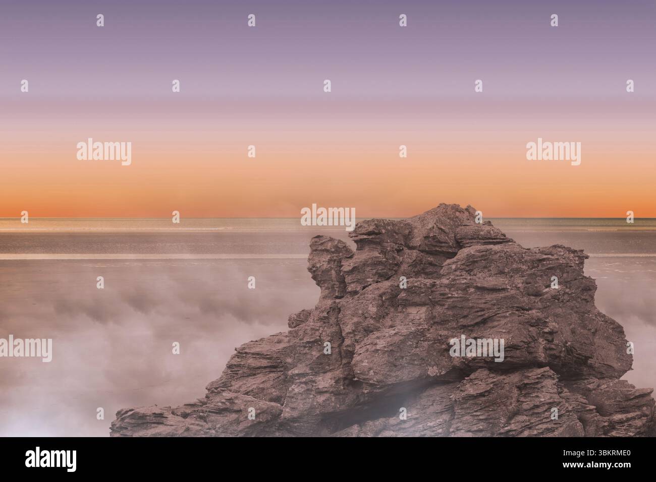 Rugged rock formation is emerging from calm sea in flat design, featuring misty waves, gradient sky Stock Photo