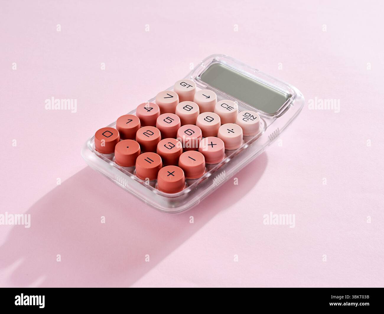 Pink calculator on a pink background, representing concepts like accounting, finance, mathematics, and business calculations Stock Photo