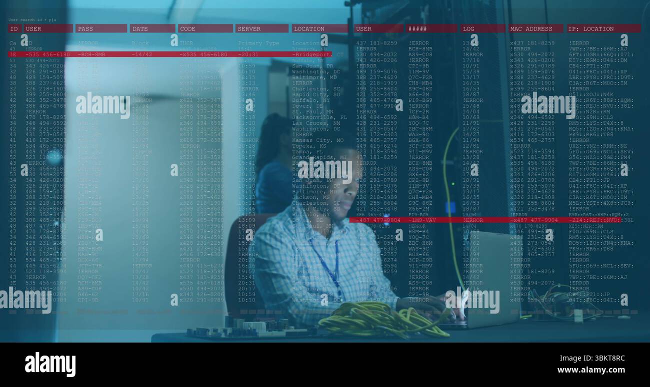 IT technician in checkered shirt configuring network gear in server room, with laptop and cables Stock Photo