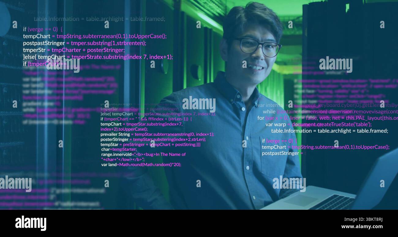 Standing Korean man holding laptop inside server room, with server racks and overlaid code text Stock Photo