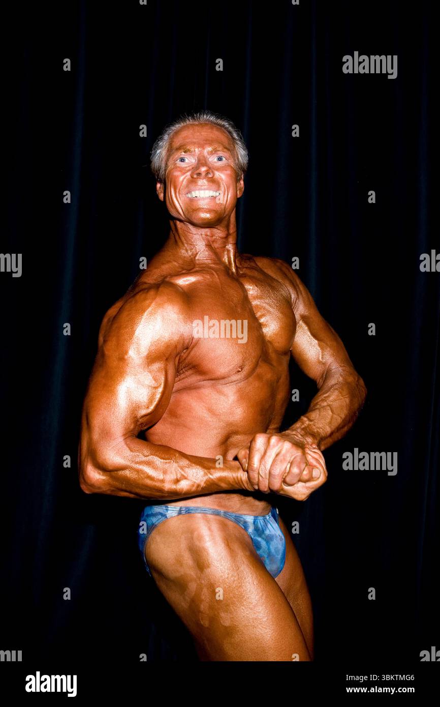Toronto Bodybuilders Senior pro bodybuilder and fitness competitor poses before he goes on ...