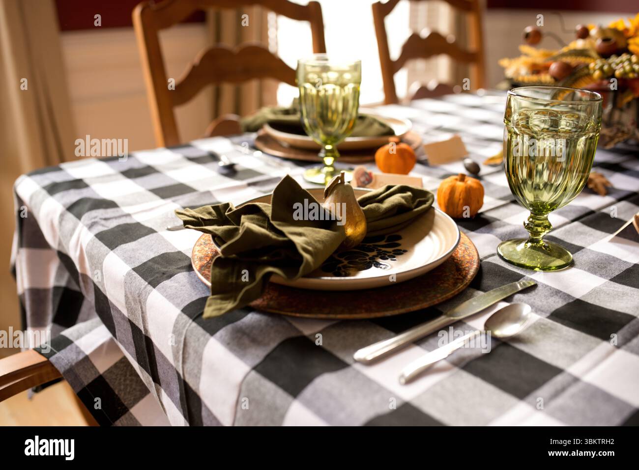 Thanksgiving table setting decorated with pumpkins and golden pear Stock Photo