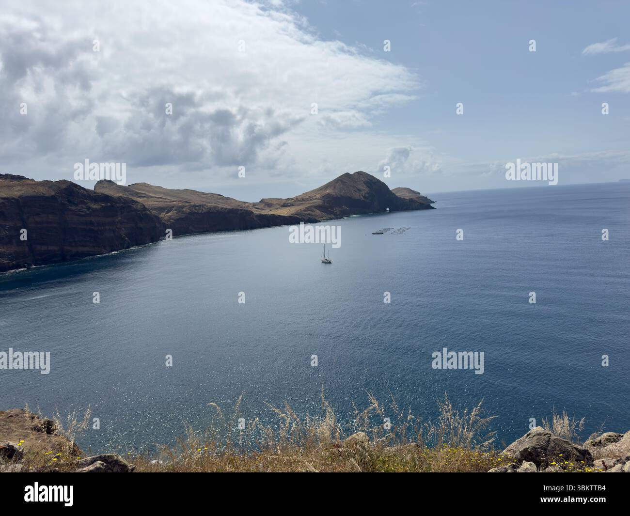 Picturesque view of the mountains surrounding the coastline of the bay on the island of Madeira, Portugal, travel - Smartphone Captured Stock Image