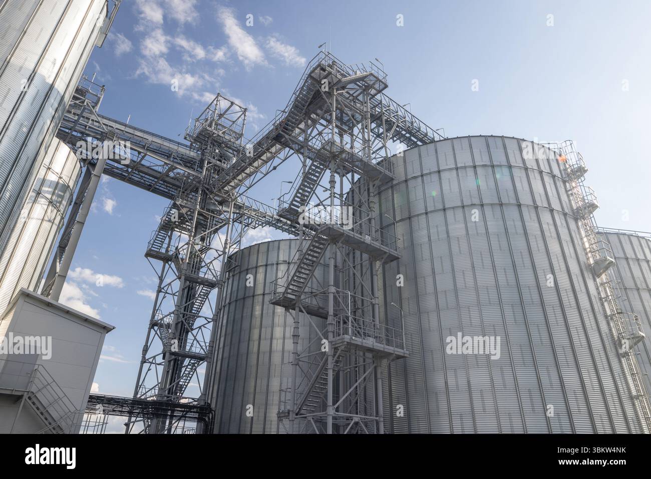 Large modern grain silos and metal storage facility with industrial ...