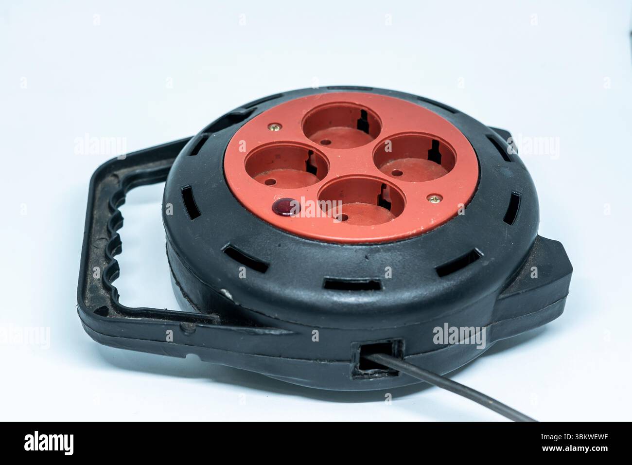 Electrical Long Extension cable cord on reel with remote socket outdoor Stock Photo