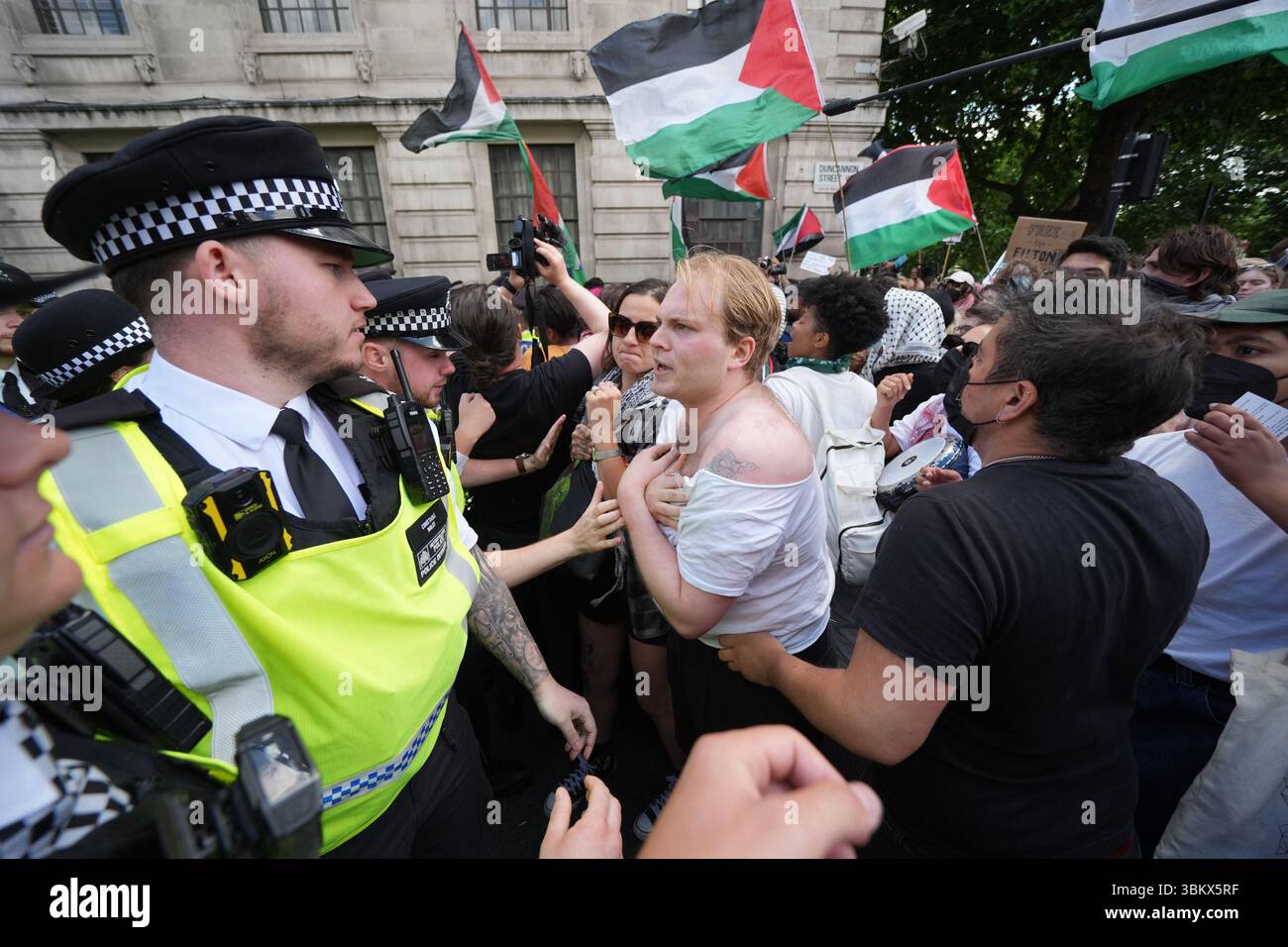 Police block the way of people taking part in a demonstration in central in London in support of Palestine Action. The Home Secretary is preparing to ban Palestine Action following the group's vandalism of two planes at an RAF base, making it a criminal offence to belong to or support Palestine Action. Picture date: Monday June 23, 2025. Stock Photo
