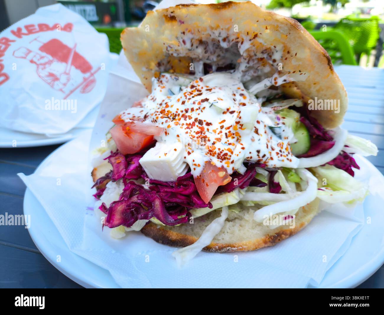 Bavaria, Germany - June 23, 2025: Fresh kebab in flatbread with lettuce ... Bavaria, Germany - June 23, 2025: Fresh kebab in flatbread with lettuce ...