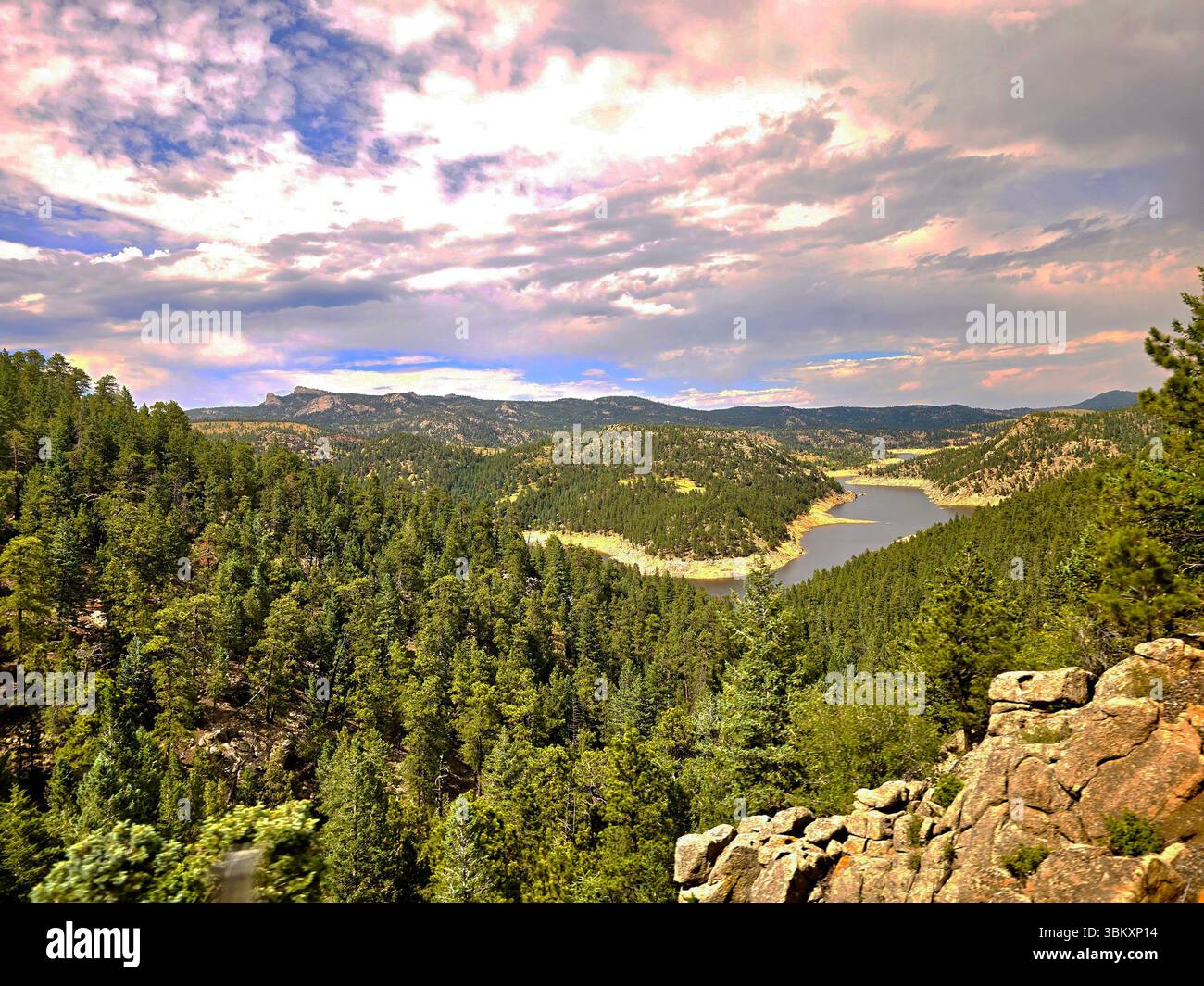 Lush forest valley with a tranquil river and layered mountains in the Colorado Rockies. - Smartphone Captured Stock Image