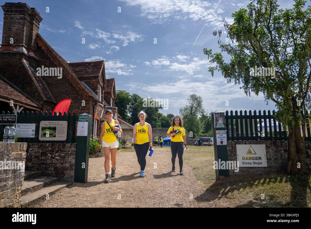 Walkers Adult participants cross the finish line at the 2025 berkhamsted Woodland Trail 2025 organised by charity DENS of Dacorum Stock Photo