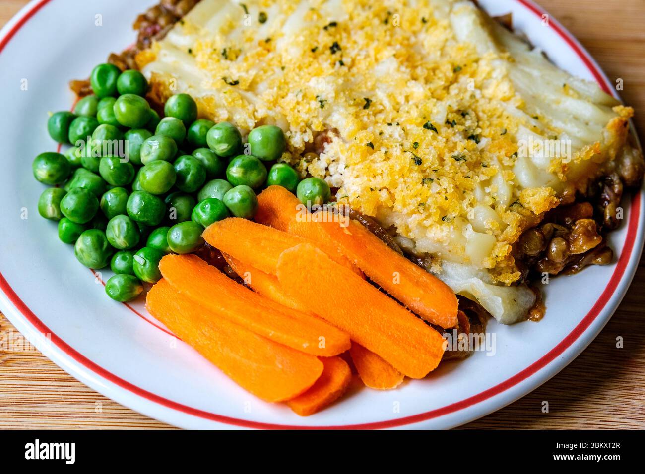 London UK, June23 2025, Vegetarian or Veggie Cottage Pie With Carrots And Peas Topped With Mash Potato Stock Photo