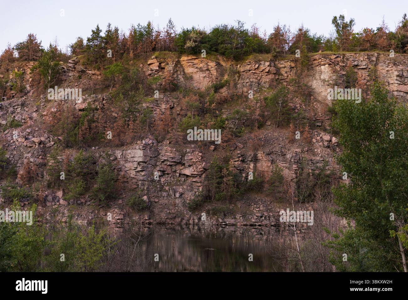 Layered rock formation with rugged texture and angular stones ...