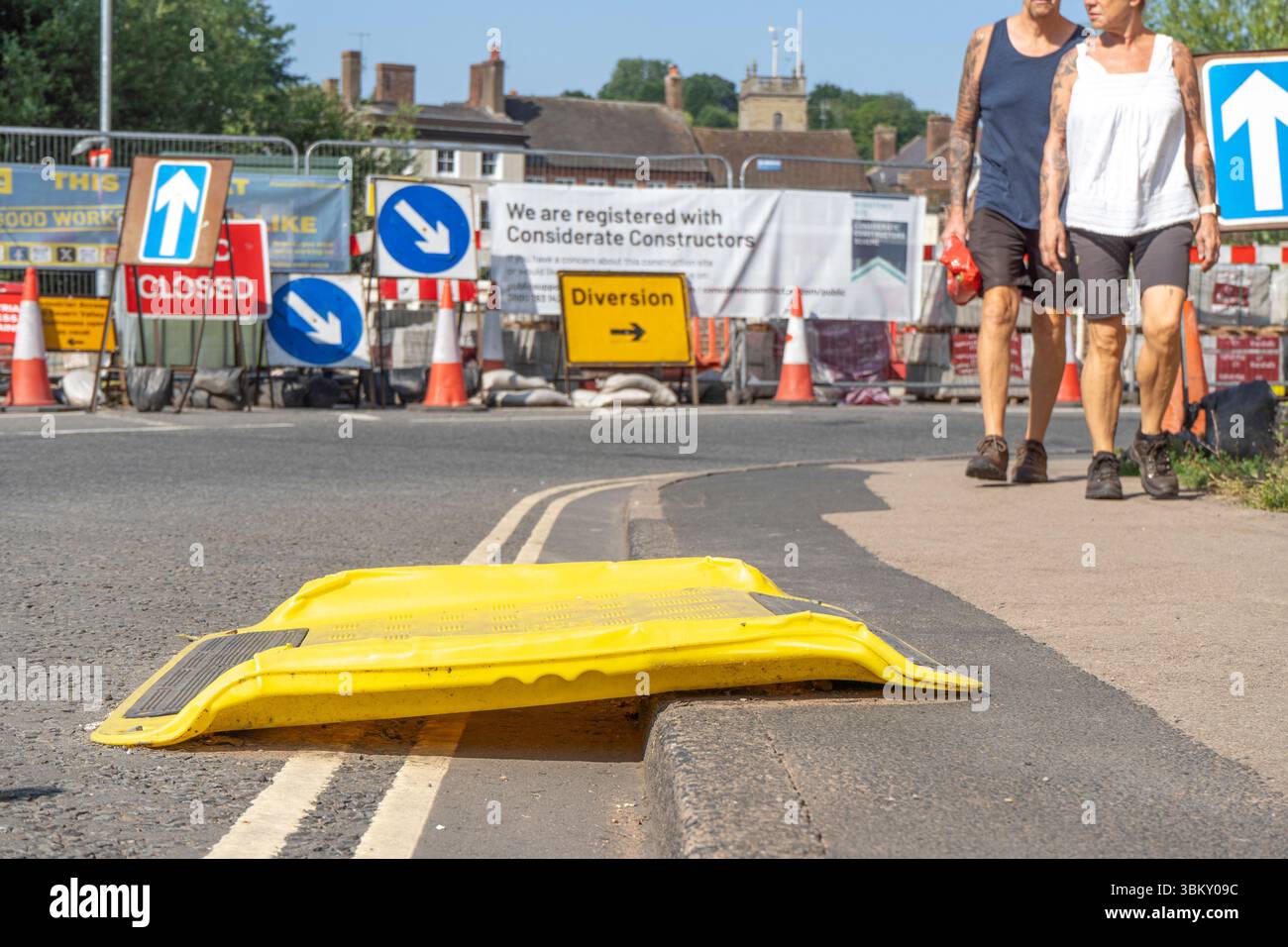 Curb Ramp Sign Wheelchair ramp over a curb on a road with roadworks and diversion sign ...