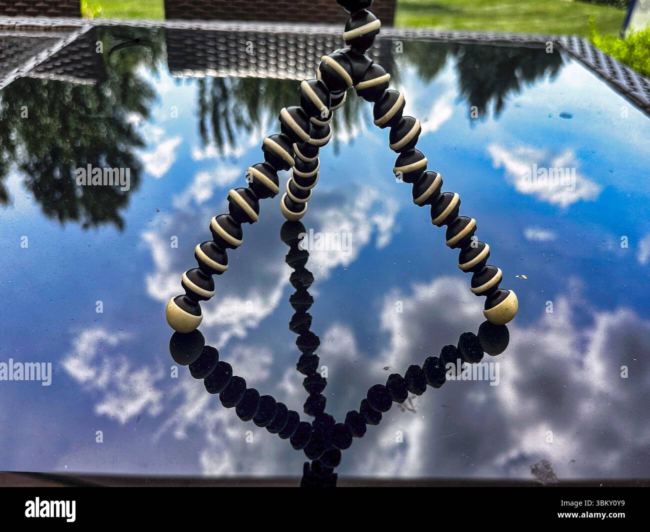 A mini tripod on a patio table. Stock Photo