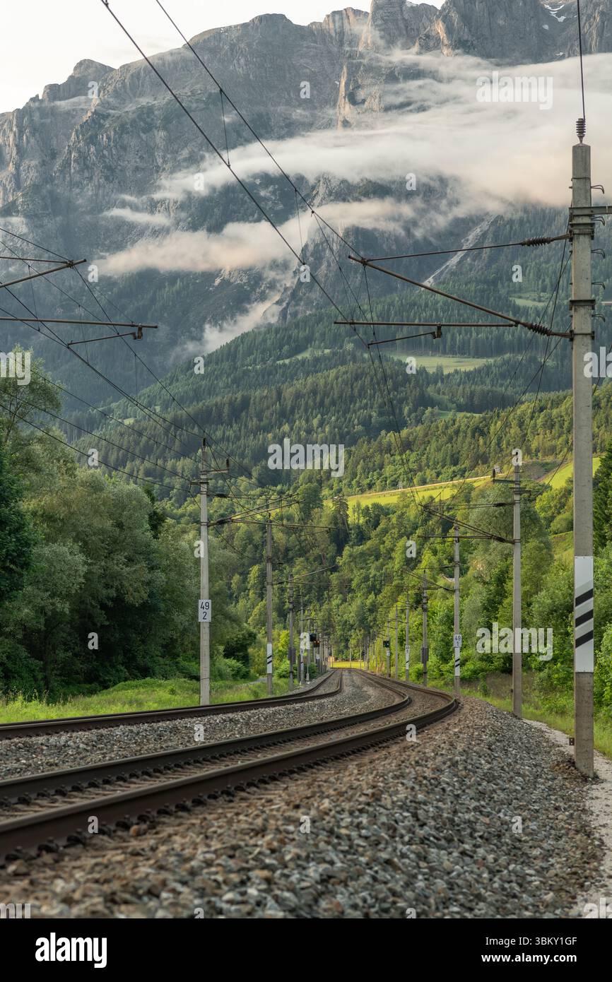 Electic railway with Austria trains in summer sunny evening near Pfarrwerfen Austria Stock Photo