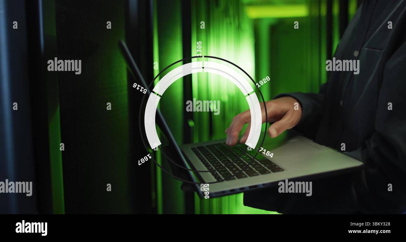 System administrator typing on laptop in data center server room, with network cables, copy space Stock Photo