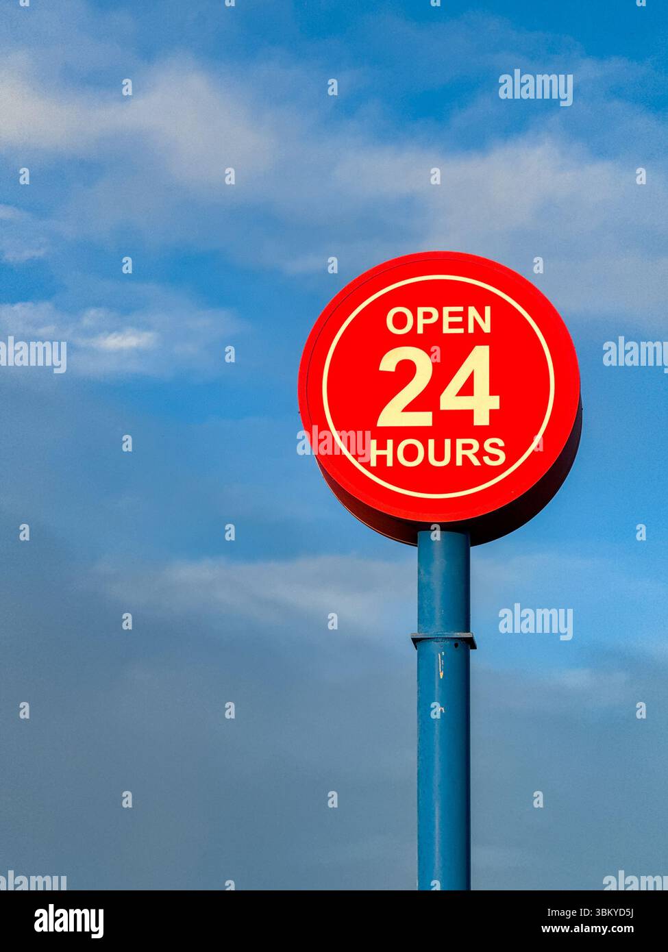 Open 24 hours sign isolated against a blue sky. No people. Copy space. - Smartphone Captured Stock Image