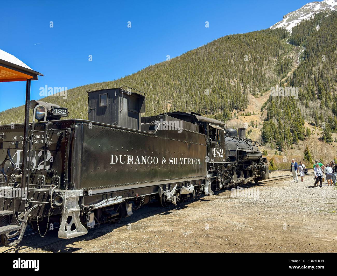 Silverton, Colorado, USA - 23 May 2025: Vintage steam engine on the Durango and Silverton narrow gauge railway at Silverton with snow capped mountain - Smartphone Captured Stock Image