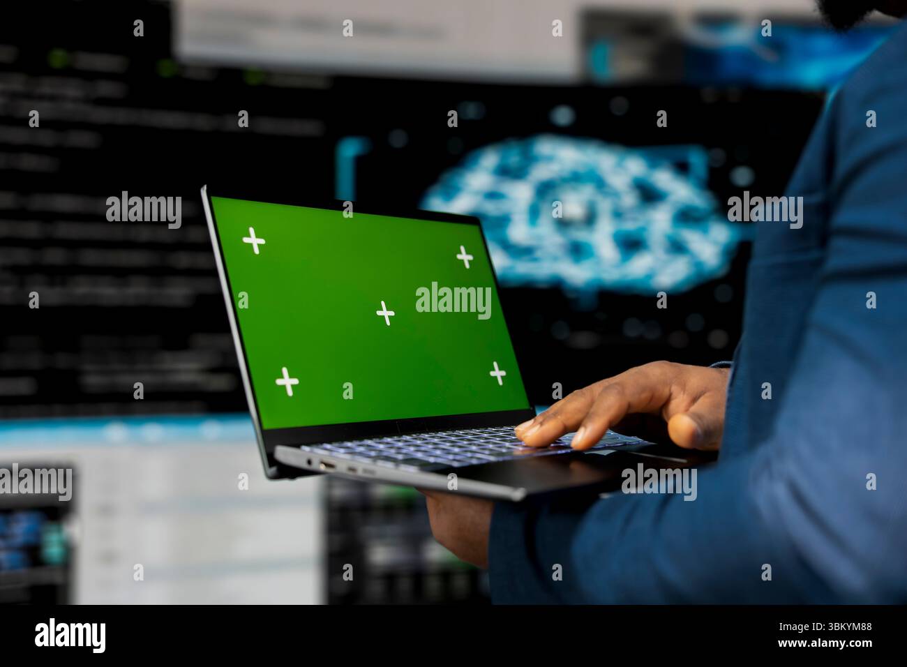 Young engineer works on binary code with copy space on laptop, reflecting the mindset of a tech world. Innovation hub with programming languages and development tools, coding life. Stock Photo