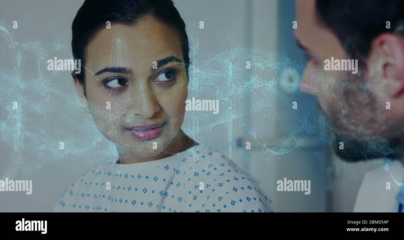 Sitting woman wearing blue-dot hospital gown facing doctor at clinic with holographic medical scan Stock Photo