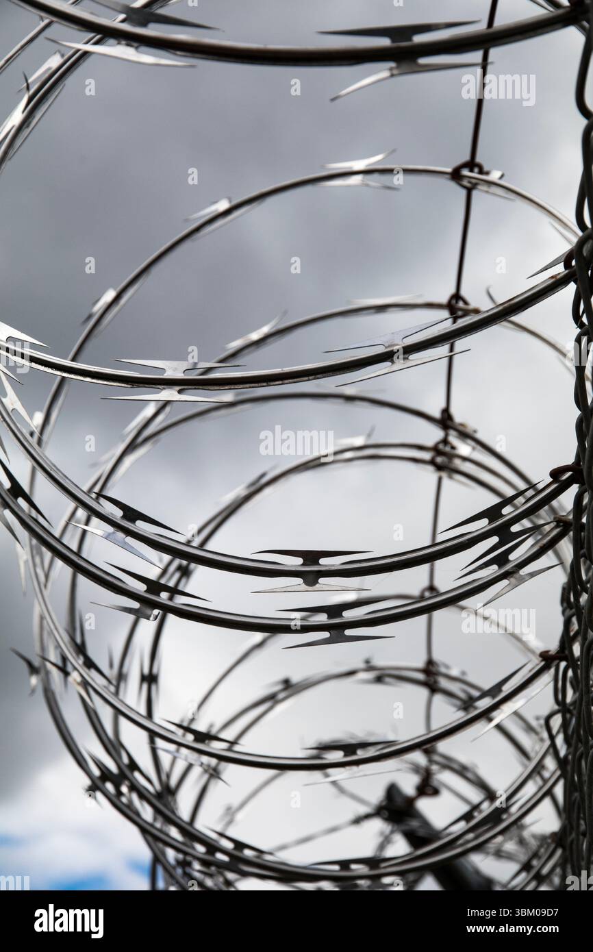 Barbed wire. Cloudy sky, dark storm clouds. Stock Photo