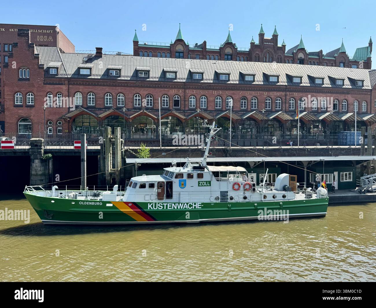 “Küstenwache” coastal patrol vessel moored along the historic Speicherstadt waterfront in Hamburg, Germany. - Smartphone Captured Stock Image