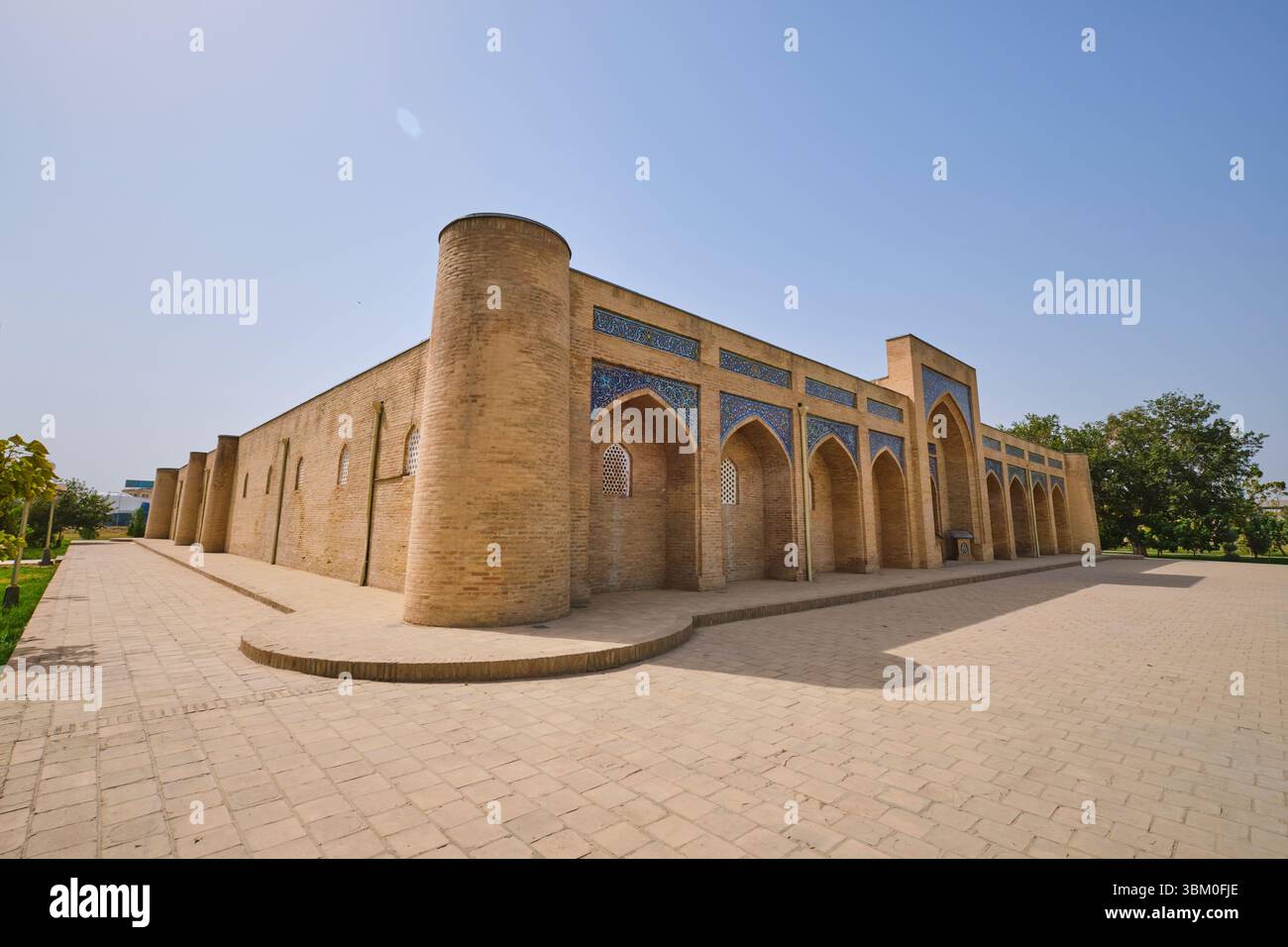 A corner view of the iconic, tan brick and blue tile building. At the ...