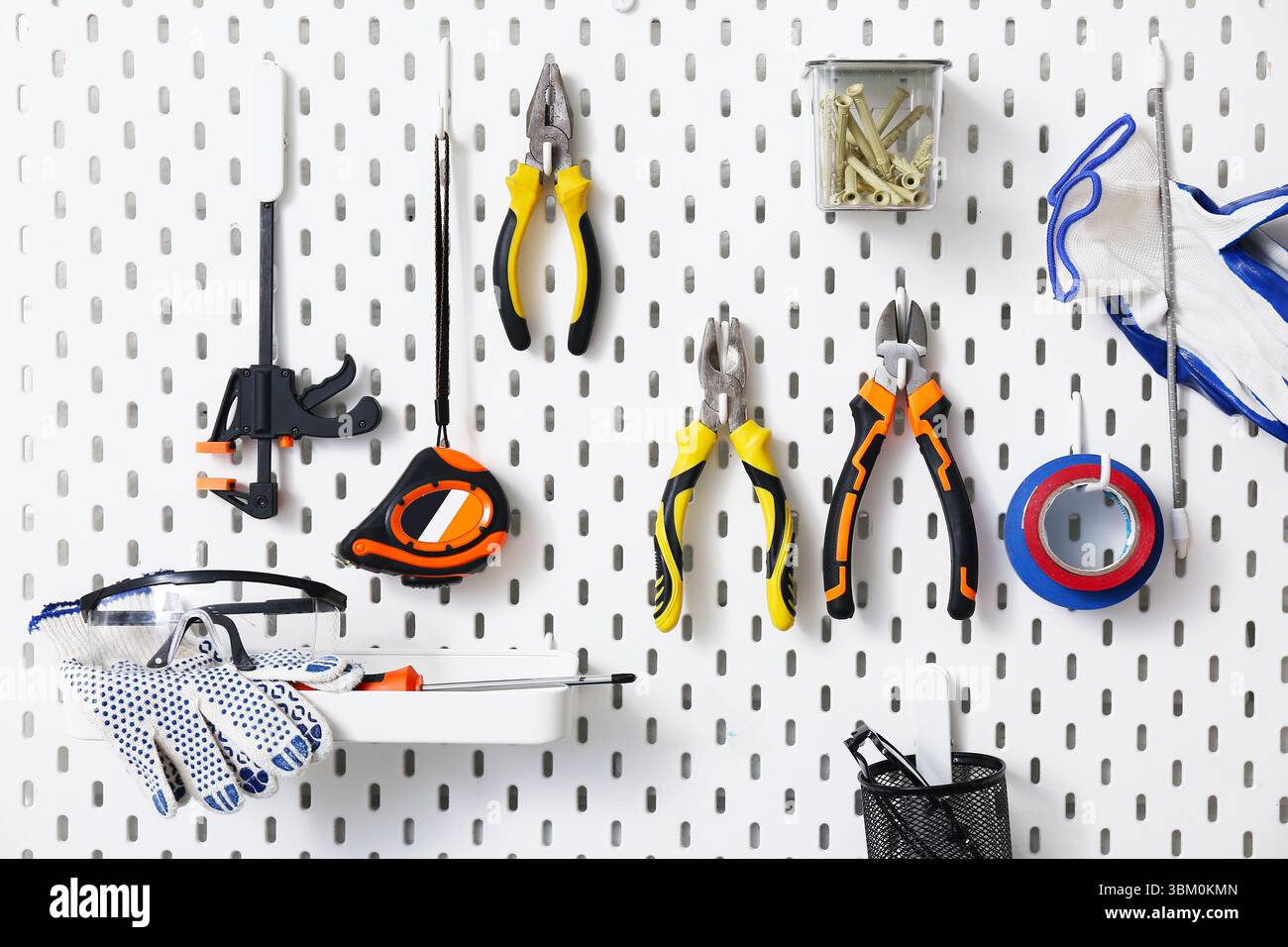 Working tools hanging on peg board Stock Photo