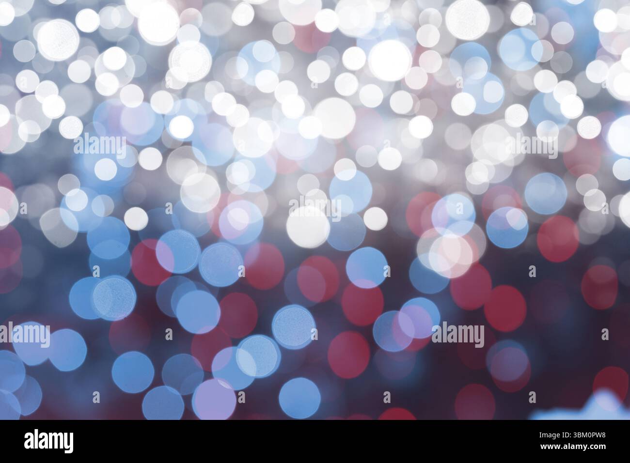 Soft circular lights are creating abstract bokeh pattern in flat design style on dark backdrop Stock Photo