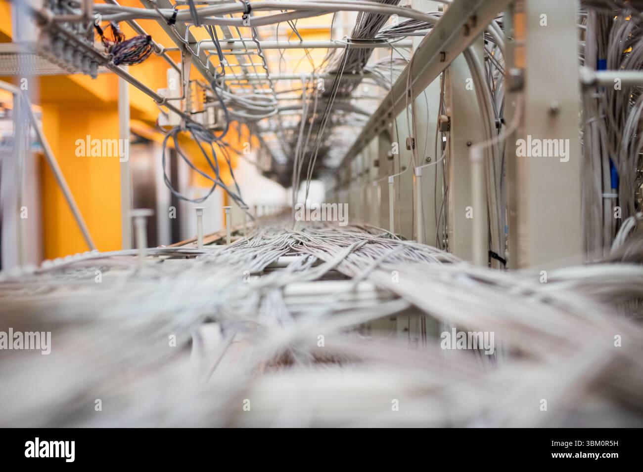 Network cables are routing through cable trays forming vanishing point ...