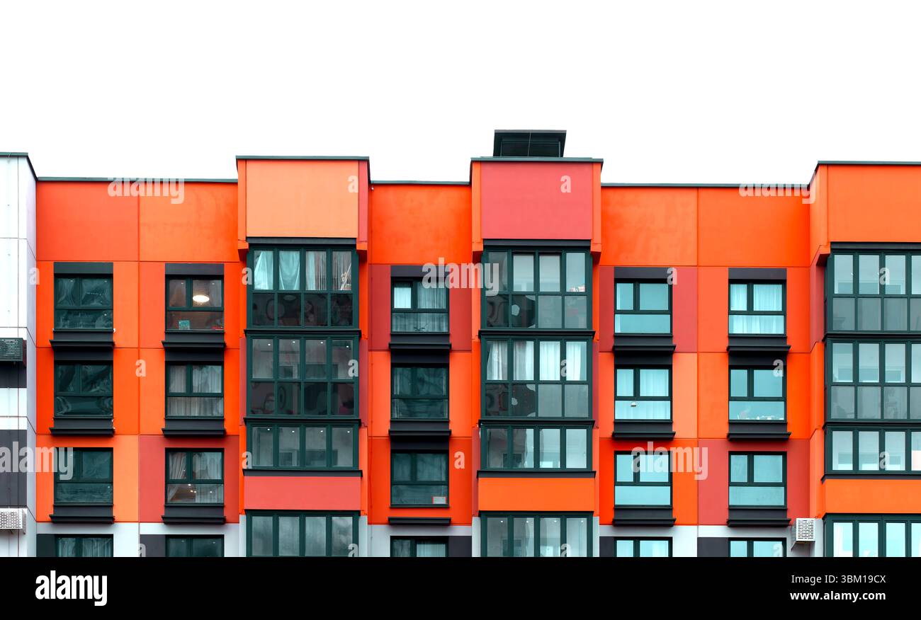Building with red and orange apartment facade featuring balconies and ...