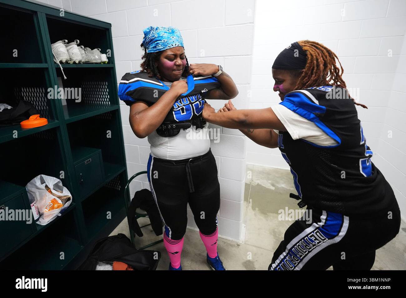 Detroit Prowl's Deja Adams, right, helps JaCree Allen with her shoulder  pads before an AWFL women's football game against the Lansing Legacy in  Allen Park, Mich., Saturday, May 10, 2025. (AP Photo/Paul
