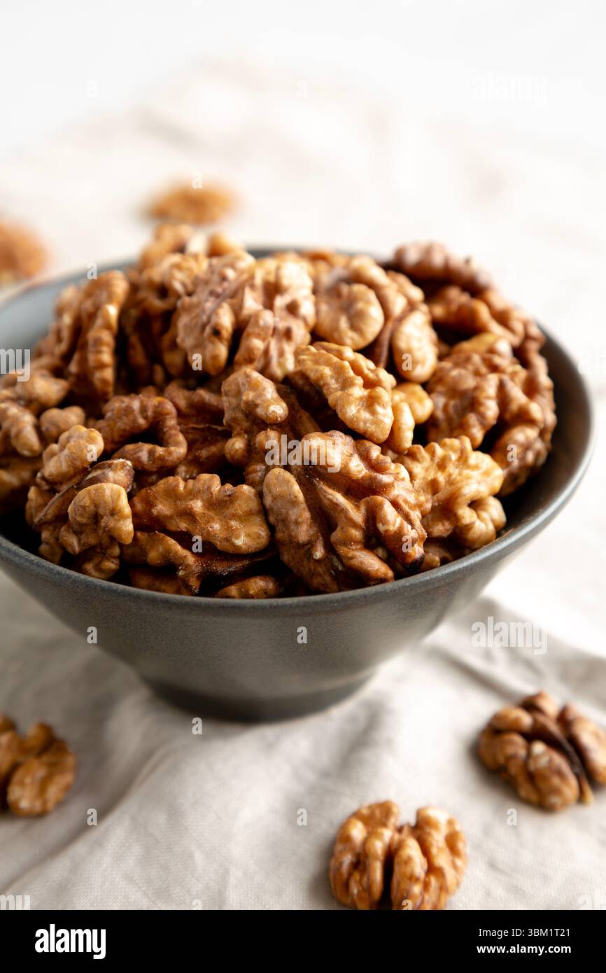 Raw Walnut Halfs in a Bowl, side view. Close-up. Stock Photo