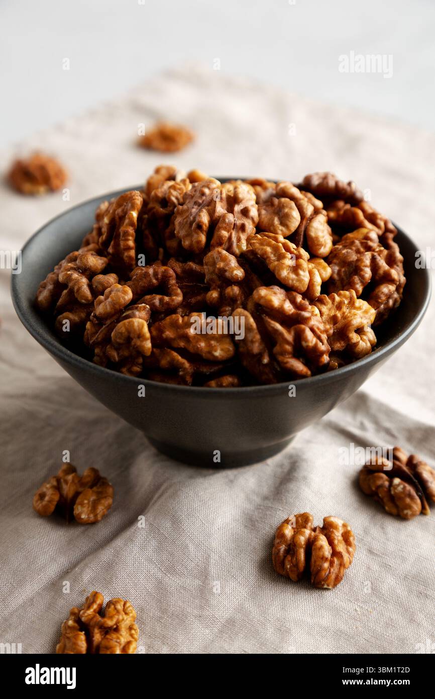 Raw Walnut Halfs in a Bowl, side view. Stock Photo