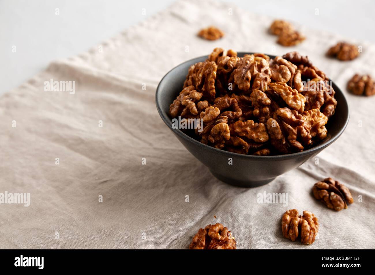 Raw Walnut Halfs in a Bowl, side view. Copy space. Stock Photo