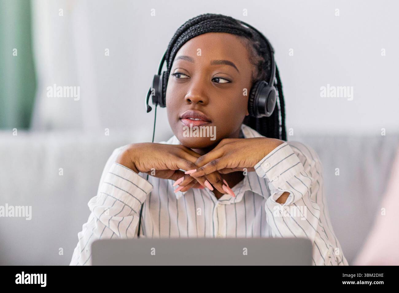 Pensive black lady having online training at home Stock Photo