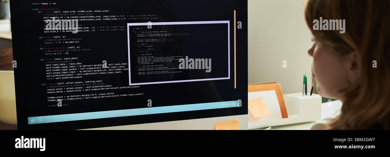 Young Caucasian Woman Developing Neural Network Code on Computer Monitor Stock Photo