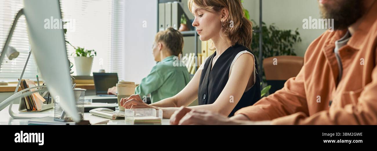 Young Caucasian Woman Developing Neural Network at Computer in Modern Office Stock Photo